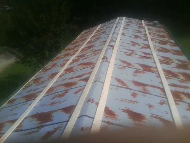 Rusted metal roof panels with new wood purlins before replacement — Storm Damage Roof Repair in Folcroft by Roofing Brothers